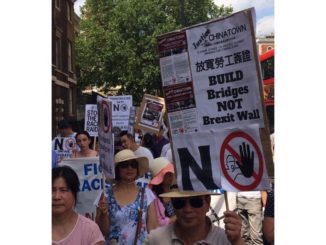 Peter Ren, owner of the New China restaurant, attends a protest in London's Chinatown on Tuesday.