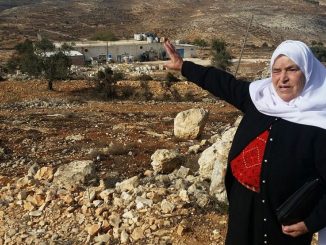 Mariam Hammad, of nearby Silwad, points to a piece of land in the West Bank she says belongs to her but was taken by Israelis to build the outpost of Amona, November 2016 (Raphael Ahren/Times of Israel)