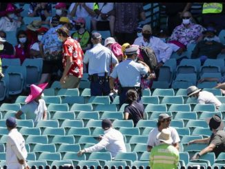 Police escort spectators from the stands during play on Day Four of the third Test match between India and Australia at the Sydney Cricket Ground on Sunday. -- AP